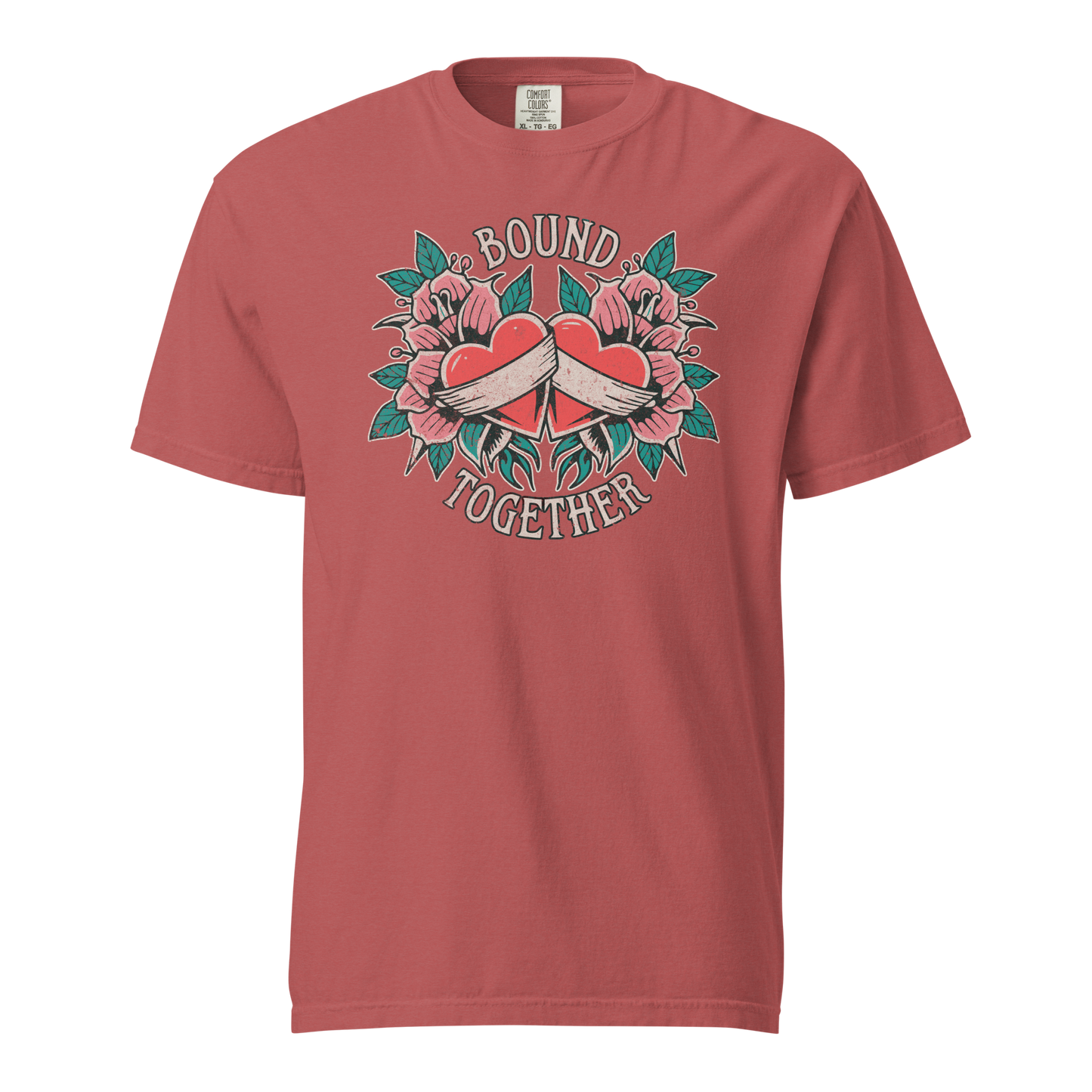 A Vintage Tattoo Inspired Design Featuring two red hearts wrapped together with a white ribbon, surrounded by pink flowers and green leaves in a symmetrical layout. The words 'BOUND' and 'TOGETHER' are displayed in bold, vintage-style serif typography above and below the hearts. The design is mocked up on a crimson comfort colors shirt.