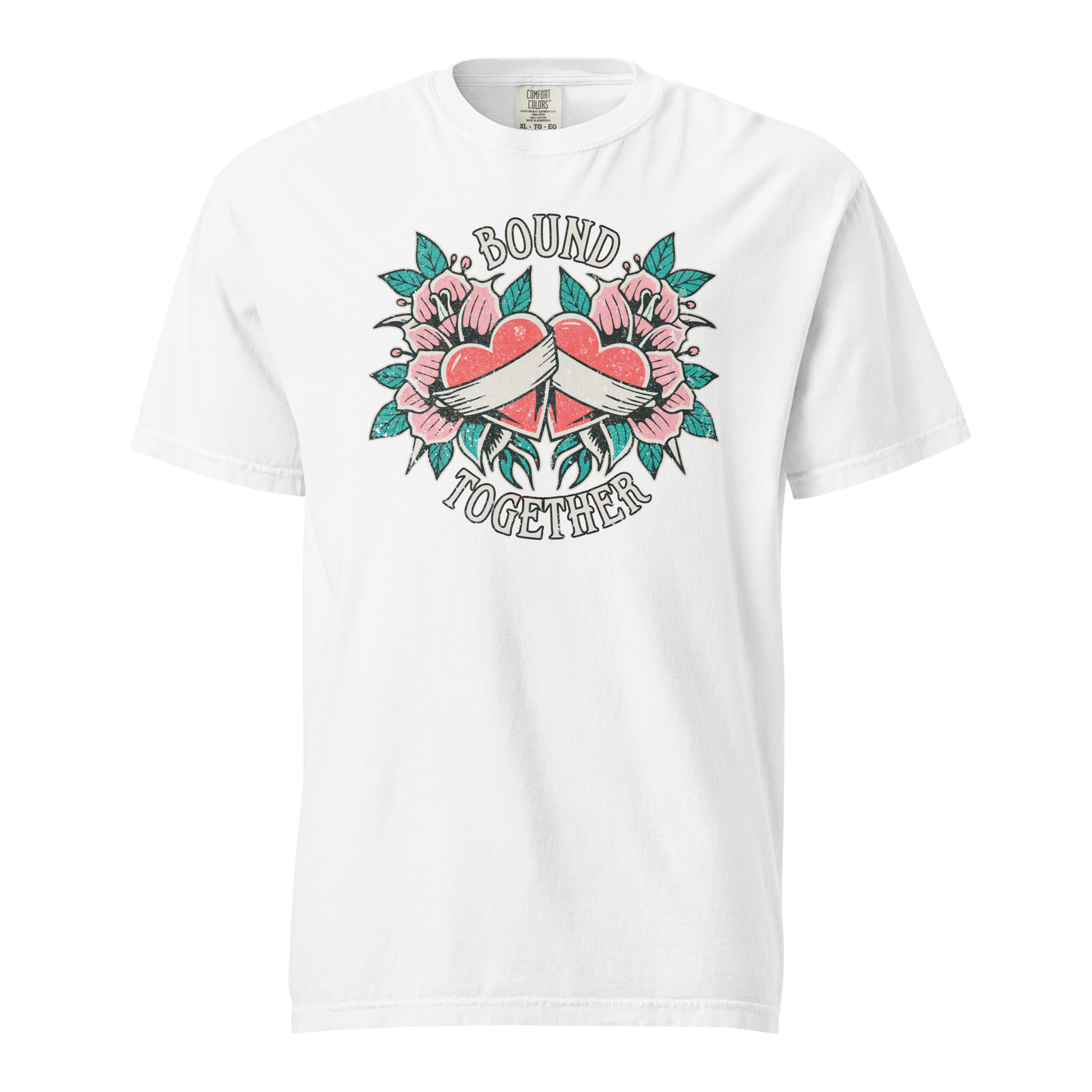 A Vintage Tattoo Inspired Design Featuring two red hearts wrapped together with a white ribbon, surrounded by pink flowers and green leaves in a symmetrical layout. The words 'BOUND' and 'TOGETHER' are displayed in bold, vintage-style serif typography above and below the hearts. The design is mocked up on a white comfort colors shirt.