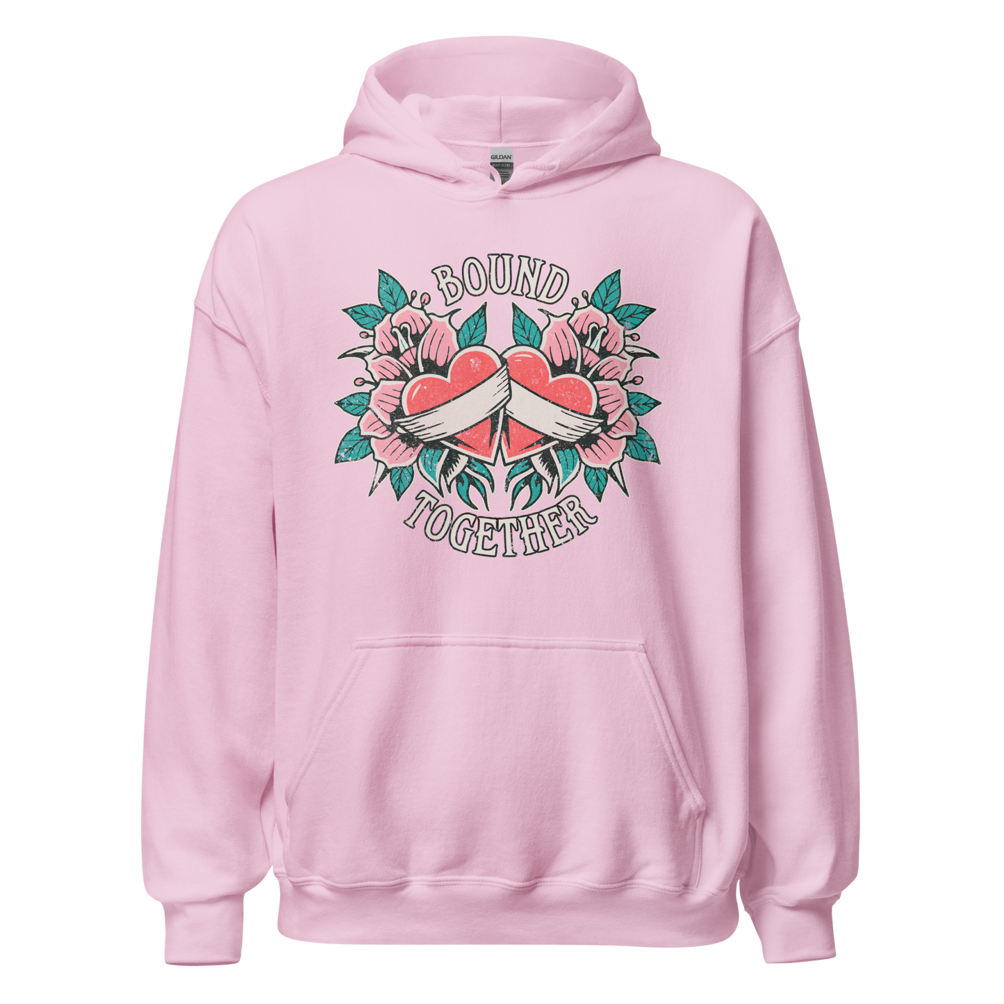 A Vintage Tattoo Inspired Design Featuring two red hearts wrapped together with a white ribbon, surrounded by pink flowers and green leaves in a symmetrical layout. The words 'BOUND' and 'TOGETHER' are displayed in bold, vintage-style serif typography above and below the hearts. The design is mocked up on a light pink gildan 18500 hoodie.