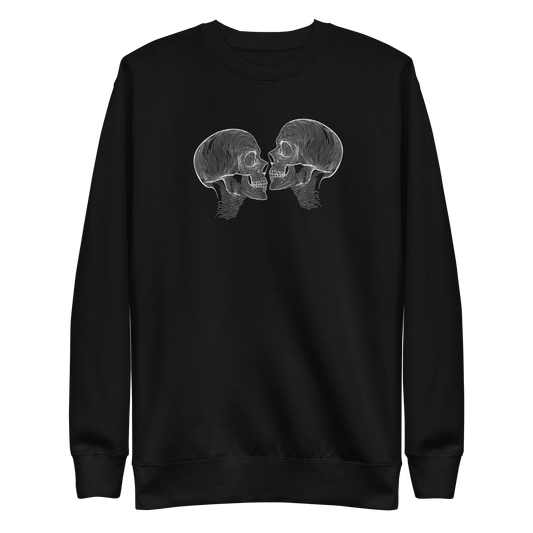 "Counterparts" design featuring two mirrored skulls with intricate white linework, symbolizing duality and connection, placed on a black sweater for a minimalist look.